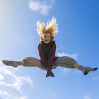 Furniture-Free Living: Why We Love It (What We’ve Learnt So Far) 6 Action shot of girl in the air after jumping on a rebounder