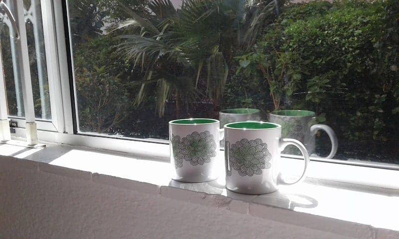 Two mugs on a windowsill