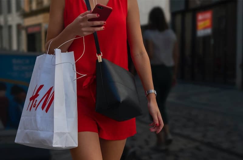 Woman holding H&M shopping bag