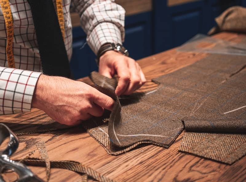 tailor cutting cloth