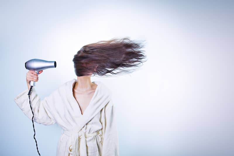Woman blowdrying hair - how to declutter your mind